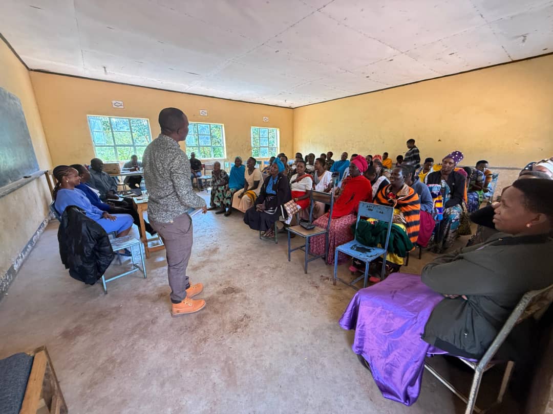 Facilitator leading discussion in rural classroom with community participants